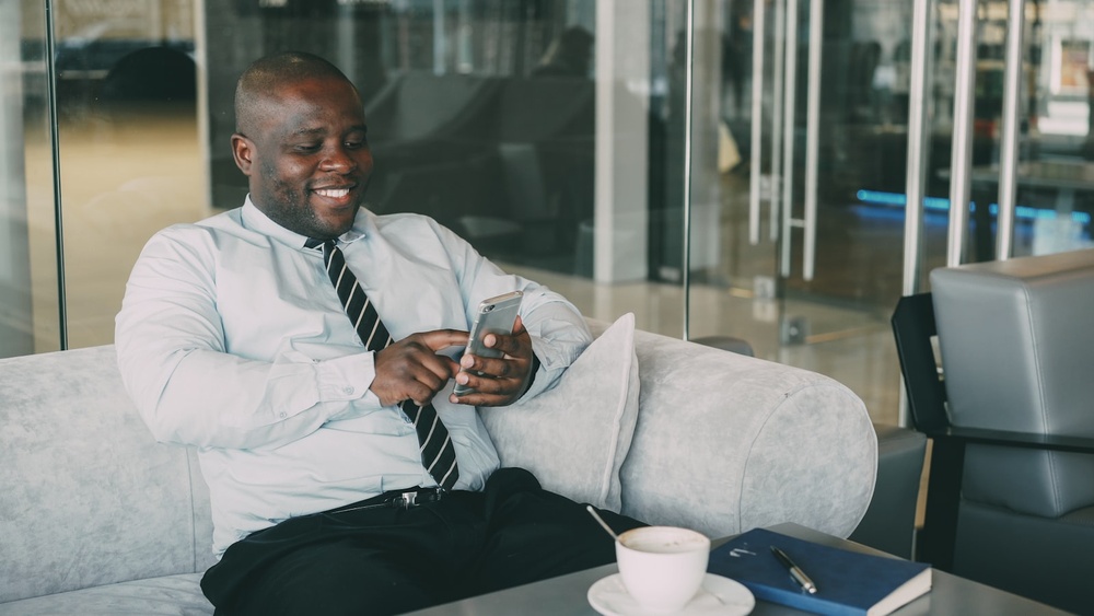 A business traveller reaching his travel consultant by phone between flights